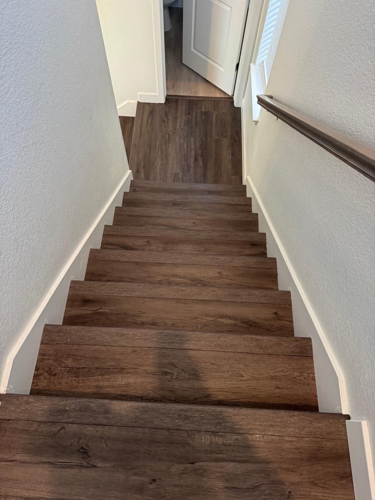 Dark wood-look flooring installed on stairs